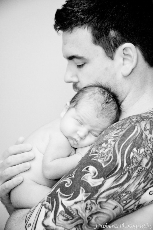 black and white of father holding a newborn baby - newborn baby portrait photography sydney